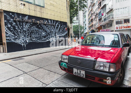 Central district Hong Kong city modern art street view with traditional style red taxi car most popular travel place in asia.,24 November 2017, Hongko Stock Photo