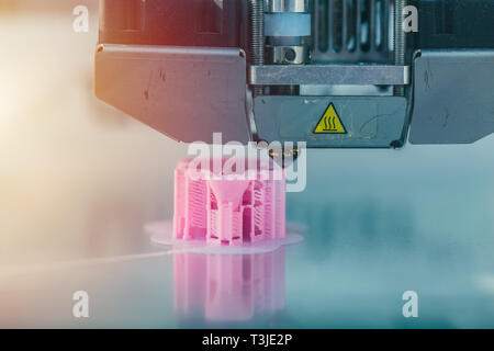 3d printer working printing plastic model. Stock Photo