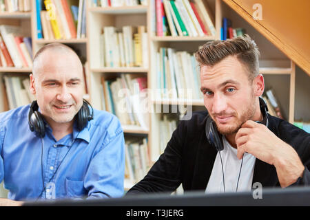 Two freelancers as competent software developers work together on the computer Stock Photo