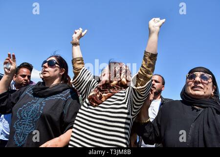 April 10, 2019 - Kashmir, J&K, India - Supporters of National Conference (NC), a mainstream political party seen chanting slogans during the ban on a main National Highway on the outskirts of Srinagar, Kashmir.The government has prohibited the movement of civilian traffic on the main National Highway to keep it open for military convoys for two days every week. The order comes weeks after 40 paramilitary troopers were killed in a suicide attack on February 14 Credit: Saqib Majeed/SOPA Images/ZUMA Wire/Alamy Live News Stock Photo