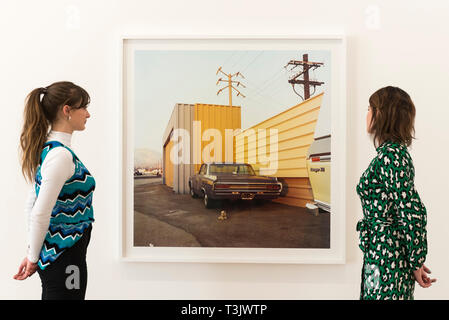 London, UK.  10 April 2019.  Staff members view a work by American photographer William Eggleston at his new exhibition '2¼' at the David Zwirner gallery in Mayfair.  The show comprises a series of square-format colour photographs taken around 1977 throughout California and the American South and will run April 12 to June 1, 2019.  Credit: Stephen Chung / Alamy Live News Stock Photo
