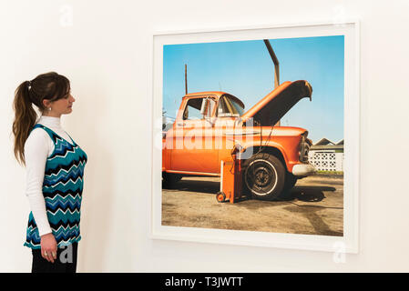 London, UK.  10 April 2019.  A staff member views a work by American photographer William Eggleston at his new exhibition '2¼' at the David Zwirner gallery in Mayfair.  The show comprises a series of square-format colour photographs taken around 1977 throughout California and the American South and will run April 12 to June 1, 2019.  Credit: Stephen Chung / Alamy Live News Stock Photo