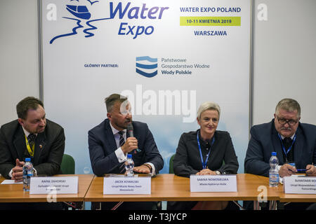 Warsaw, Mazowieckie, Poland. 10th Apr, 2019. Local authorities seen speaking to the audience during the exhibition and conference. During the Water Expo Poland International Exhibition and Conference, a group of ecological activists from Extinction Rebellion unexpectedly stripped off to highlight how dangerous for the environment is building canals and waterways on rivers. Water Expo is Poland's only exhibition and conference event to comprehensively cover all aspects of investments linked to inland waters. Credit: Attila Husejnow/SOPA Images/ZUMA Wire/Alamy Live News Stock Photo