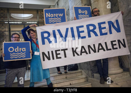 Warsaw, Mazowieckie, Poland. 10th Apr, 2019. A group of activists seen holding placards with the names of Polish rivers and a big banner saying Rivers not canals during the exhibition and conference. During the Water Expo Poland International Exhibition and Conference, a group of ecological activists from Extinction Rebellion unexpectedly stripped off to highlight how dangerous for the environment is building canals and waterways on rivers. Water Expo is Poland's only exhibition and conference event to comprehensively cover all aspects of investments linked to inland waters. (Credit Imag Stock Photo