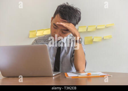 Tired office man worried about financial report  Stock Photo