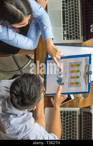 High angle view of business team discuss about financial report Stock Photo