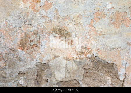 Textured grunge background. Old plastered wall with a multilayer cracked coating. Grunge texture with a deep pattern on whitewashed wall Stock Photo