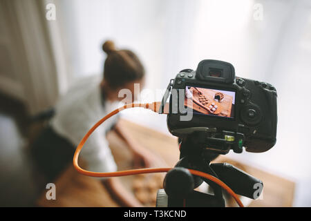 Food blogger recording video in kitchen, focus on camera display. Pastry chef making a new vlog on preparing dessert. Stock Photo