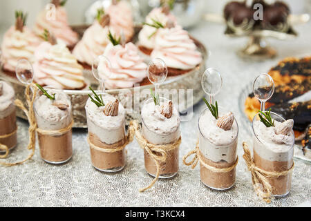 Candy bar. Festive table with deserts,  tartlets, cookies and cakepops. Stock Photo