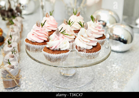 Candy bar. Festive table with deserts,  tartlets, cookies and cakepops. Stock Photo