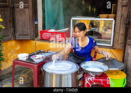 Vietnamese woman making rice paper cakes on a back street in the old quarter of Hoi An, Quang Nam Provence, Vietnam, Asia Stock Photo