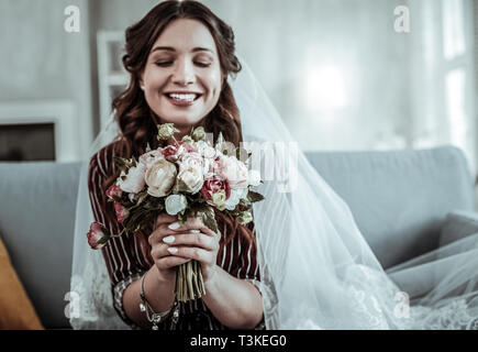 Smiling woman fitting a veil before the wedding Stock Photo