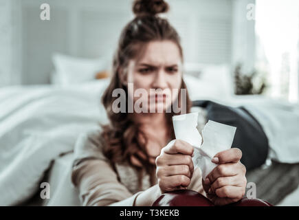Upset woman breaking the photo of her ex Stock Photo