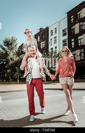 Nice young woman holding her husbands hand Stock Photo