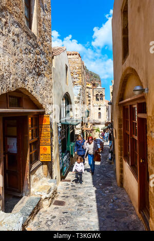 Monemvasia, Greece - March 31, 2019: Street view with old houses and greek restaurant tavern in ancient town, Peloponnese Stock Photo