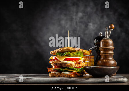 Tall club sandwich with eggs, turkey and bacon Stock Photo