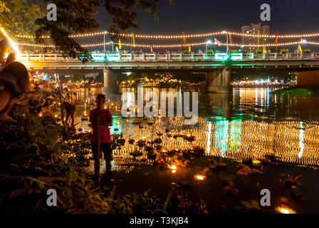 Chiang Mai, Thailand - Nov 2015: Floating lanterns with flowers on the river fro Yi Peng (Yee peng) festival in Chiang Mai, motion image Stock Photo