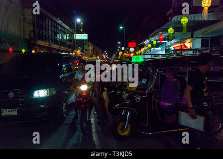 Chiang Mai, Thailand - Nov 2015: Tuk tuk taxi waiting by the road at night Stock Photo
