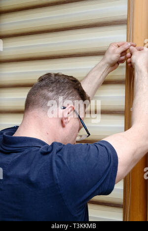 Window blinds installation Stock Photo