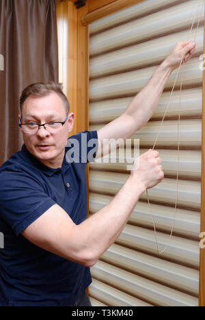 Window blinds installation Stock Photo
