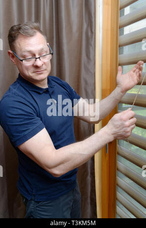 Window blinds installation Stock Photo
