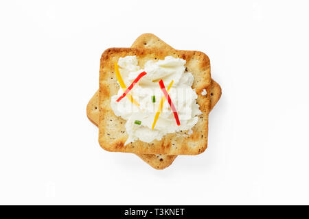 Lactose Free Cheese Spread on Crackers garnished with bell pepper Stock Photo