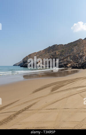 Empty Yiti Beach in a summer morning tire tracks on the sand near Muscat - Sultanate of Oman Stock Photo