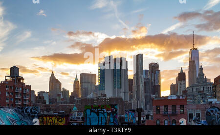 NEW YORK CITY - CIRCA 2017: Sunset light shines behind the buildings of the lower Manhattan skyline in NYC. Stock Photo