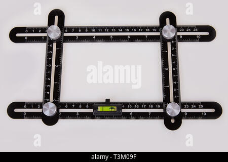 Black multi function Ruler isolated on white background. Ultimate Irregular Shape Copy Tool. Universal Easy Angle Ruler. Multi Angle Measuring Tool. Stock Photo