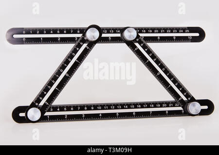 Black multi function Ruler isolated on white background. Ultimate Irregular Shape Copy Tool. Universal Easy Angle Ruler. Multi Angle Measuring Tool. Stock Photo