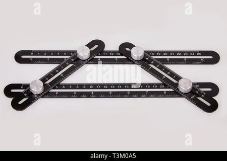 Black multi function Ruler isolated on white background. Ultimate Irregular Shape Copy Tool. Universal Easy Angle Ruler. Multi Angle Measuring Tool. Stock Photo