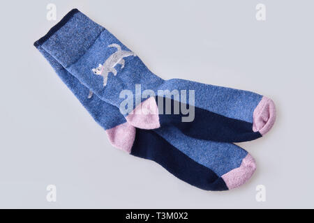 Pair of women's socks isolated on white background. Child's striped socks, white and pink socks Stock Photo