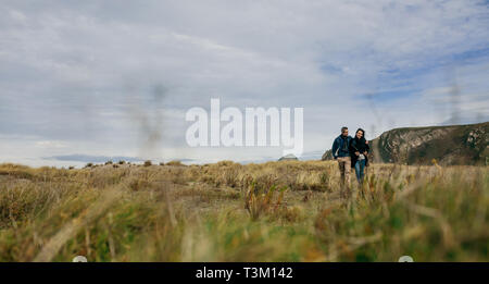 Young couple taking a walk near the coast Stock Photo