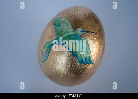 Golden Easter egg with the bird painted Stock Photo