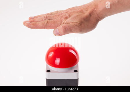 Hand pushing a red buzzer Stock Photo