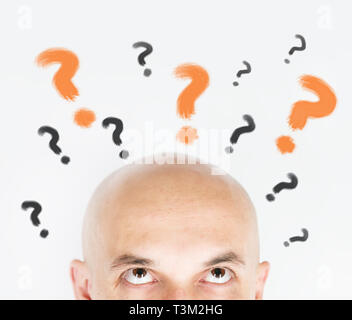 man thinking with question marks Stock Photo