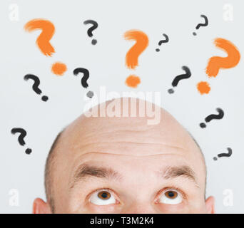 man thinking with question marks Stock Photo