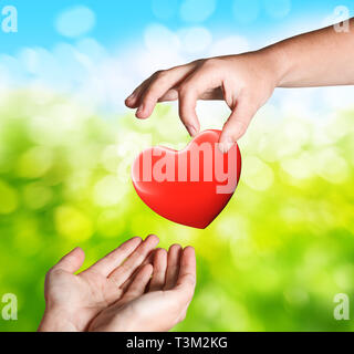 hands with red heart giving concept Stock Photo