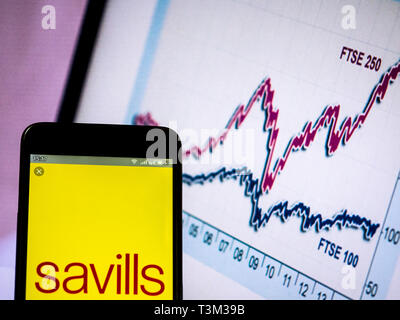 In this photo illustration, the Savills logo is seen displayed on a ...