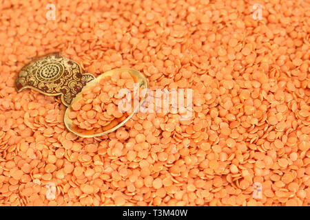 Close up of Split Red Lentils with a Gold Spoon Stock Photo