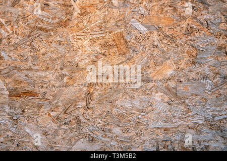 OSB boards compressed sawdust or chipboard. Abstract texture background compressed sawdust or pressed wooden panel. Close-up. Stock Photo