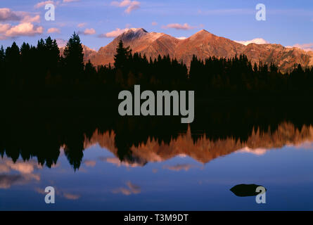 USA, Colorado, Gunnison National Forest, Alpenglow on Mount Owens in the Ruby Range which reflects in Lost Lake Slough. Stock Photo
