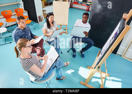 Group of art students learning to paint in a workshop at the Art Academy Stock Photo