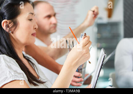 Young Asian woman as art student learns painting in a seminar of art academy Stock Photo