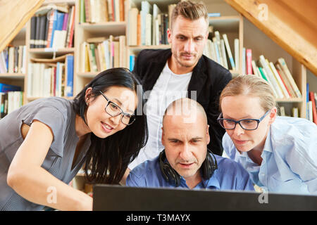 Successful Startup Business Team People Look Together On Computer Monitor Stock Photo