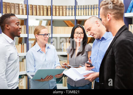 Group of young students or software developers using computers in a workshop Stock Photo