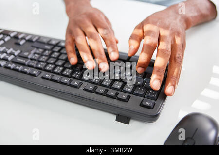 Hands are typing on computer keyboard as a concept for programming and development Stock Photo