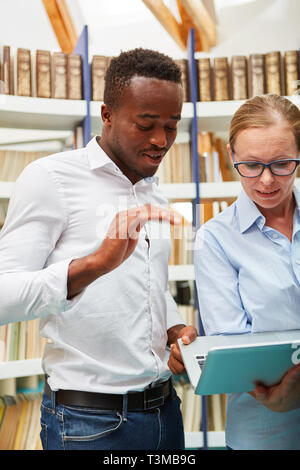 Two students or software developers work together with the laptop computer Stock Photo