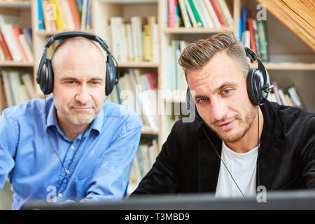 Two Freelancers as Software Developers Team Look Together on Computer Monitor Stock Photo