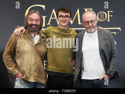 Left to right; actors Ian Beattie, who plays Meryn Trant, Isaac Hempstead Wright, who plays Bran Stark, and Liam Cunningham, who plays Davos Seaworth, at the launch of the Game of Thrones touring exhibition at the Titanic Exhibition Centre in Belfast. Stock Photo